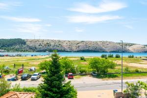 a view of a parking lot and a lake at Apartments Marija I in Lopar