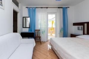 a hotel room with two beds and a window at Apartments Marija I in Lopar
