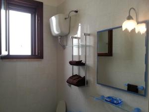 a bathroom with a mirror and a toilet and a window at Giu&Giu in Santa Caterina di Nardò