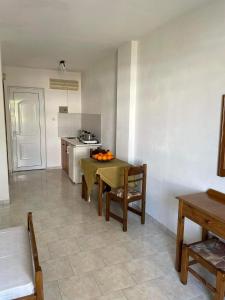 a kitchen with a table with oranges on it at STUDIO ZOE in Marmari