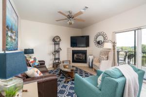 a living room with a couch and a fireplace at Natalie's Nook, Lake Hideaway near Downtown Fun! in Hot Springs