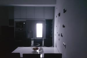 a kitchen with a white table and a window at ARTemisia in Kranidi