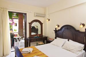 A bed or beds in a room at Trefon Hotel Apartments and Family Suites