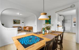 a kitchen and dining room with a table and chairs at Lovely Home In Nexø With Kitchen in Neksø