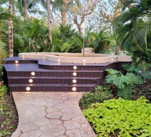 a fountain in a garden with plants and trees at Corasol Nick Price By PARR CONDOS in Playa del Carmen