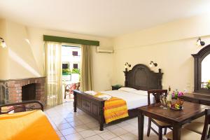 A bed or beds in a room at Trefon Hotel Apartments and Family Suites