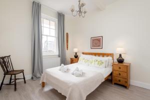 a bedroom with a bed with towels on it at The Tron Square Residence in Edinburgh