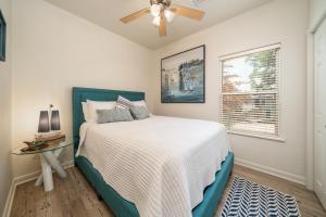 a bedroom with a bed and a ceiling fan at Natalie's Nook, Lake Hideaway near Downtown Fun! in Hot Springs