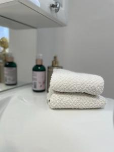 a stack of towels on a counter in a bathroom at Boutique Haus Sissi in Füssen