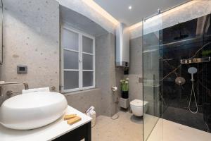 a bathroom with a toilet and a glass shower at Flora-heartbeat old city three bedrooms apartment in Dubrovnik +55 photos