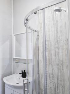 a bathroom with a shower and a sink at Portrush By The Sea - 3 Dunluce Park in Portrush