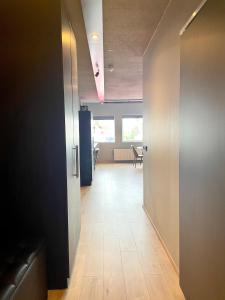 an office hallway with a door leading to a waiting room at Modern Apartment With Hot Tub in Akureyri in Akureyri