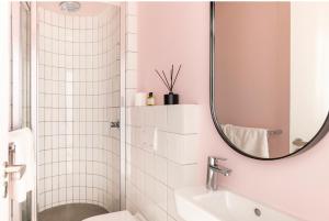 a white bathroom with a mirror and a sink at The little Flamingo in Cape Town +7 photos