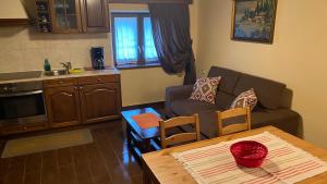 a kitchen and a living room with a couch and a table at Eleatis in Margarítion