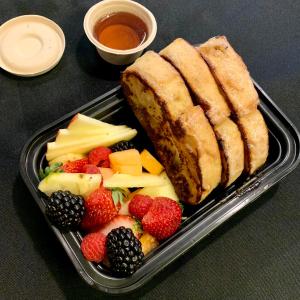 a plastic container of food with fruit and bread at The Nutmeg Vermont in Wilmington