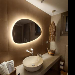 a bathroom with a sink and a mirror at Phoenix Apartments Parga in Parga