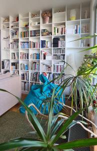 a living room with a book shelf filled with books at Casa de Svana Bratislava in Bratislava