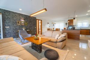 a living room with a couch and a table at Holiday home Carpinus in Široki Brijeg