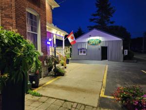 a building with a sign on the side of it at Maple Leaf Motel in Goderich