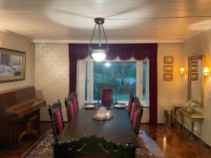 comedor con mesa, sillas y piano en Family house 150m2 in Kauhava down town en Kauhava
