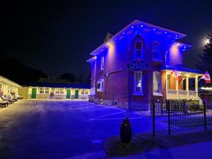 a building with blue lights on it at night at Maple Leaf Motel in Goderich