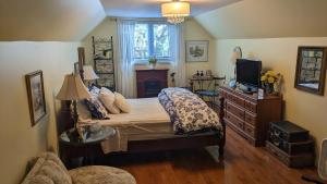 a bedroom with a bed and a television in it at Greater Toronto B&B in Oakville