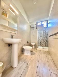 a bathroom with a sink and a toilet at A Casa dei Bruno B&B in Pozzuoli