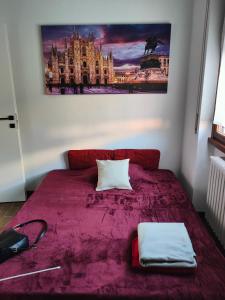 ein Schlafzimmer mit einem lila Bett mit einem Bild an der Wand in der Unterkunft Appartamento 2 del Vecchio Convento in Orino