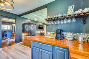 a kitchen with blue cabinets and a counter top at Jacksonville Vacation Rental with Deck! in Jacksonville