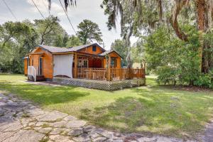 a cabin in a yard with a fence at Jacksonville Vacation Rental with Deck! in Jacksonville