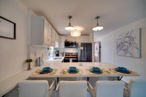 a kitchen with a large table with chairs in it at Kauai Vacation Rental Walk to Kalapaki Beach! in Lihue