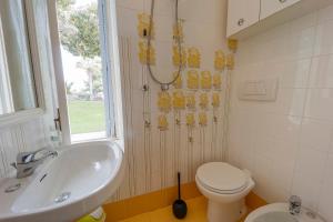 a bathroom with a toilet and a sink at Casa Nelly in Ospedaletti +16 photos