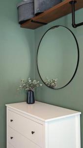 a mirror on top of a dresser in a room at Stylish 2 bedroom flat in Angel Central Location in London