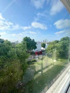 a view from a window of a street with trees at Stylish 2 bedroom flat in Angel Central Location in London