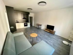 a living room with a couch and a table at Central Apartments Opava - Modern in Opava