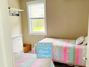 a bedroom with a bed with a sign on it at Premier Waterfront Cottage 2 in Riverhead