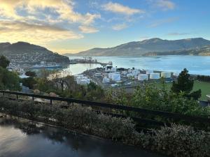 a view of a river with a city and mountains at Sanctuary By The Sea in Christchurch