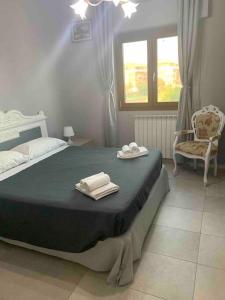a bedroom with a large bed and a chair at Rome's Harbour all year in Lido di Ostia