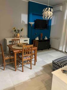 a dining room with a table and chairs and a tv at Rome's Harbour all year in Lido di Ostia