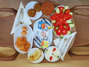 a table with plates of food on it at Tourist Palace Hotel in Cairo +21 photos