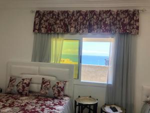 Una cama o camas en una habitación de Grand appart avec vue sur mer