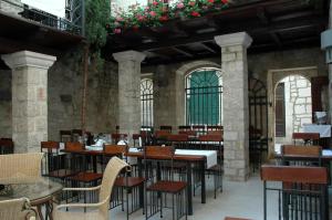 an empty restaurant with tables and chairs and flowers at B&B Rooms Old Town Rab in Rab +62 photos