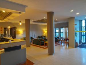 a lobby with columns and a living room at Flag Hotel Guimarães-Fafe in Fafe