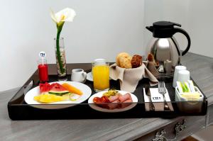 a tray of breakfast food on a table at NH Boulevard del Río Cali in Cali