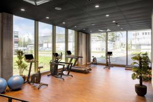 a large room with chairs and desks and windows at Radisson Hotel & Suites Zurich in Opfikon