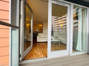 a sliding glass door on a house with a living room at Canary Wharf, E14 9PW, 2 Bedroom Apartment in London