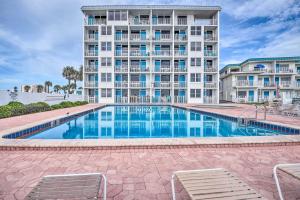 a swimming pool in front of a building at Ocean Jewels Resort Studio with Community Perks! in Daytona Beach