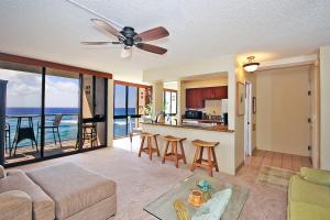 a living room with a couch and a kitchen at Kuhio Shores 416 in Koloa