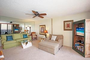a living room with a couch and a ceiling fan at Kuhio Shores 416 in Koloa