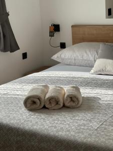 a pair of towels sitting on top of a bed at Apartment Summer Night in Preko